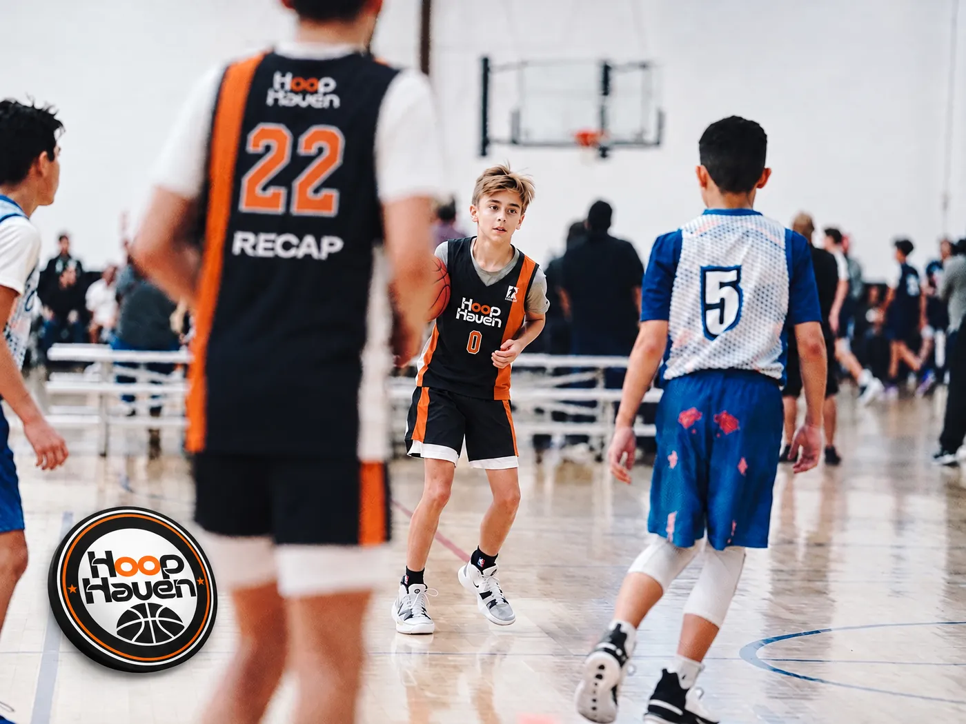A Hoop Haven player bringing the ball up court in a Recap-sponsored vest
